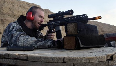 
              FILE - In this Dec. 23, 2012 file photo, Michael Reed, of Cedar Park, Texas, shoots an AR-15 rifle, at Dragonman